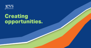 Image description: A dark blue background with a rainbow (light blue, white, green, orange) across the middle (from wider on the lower left to more narrow on the upper right side). With a logo in the top left corner that says: JEVS Human Services (white lettering). With text in the lower right corner that says: Creating opportunities.